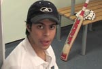Indian Student in UK with Cricket Bat